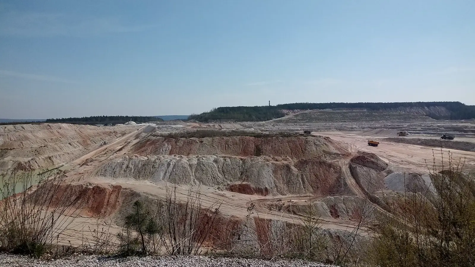 Open-pit kaolin quarry with white clay benches (generic illustration)
